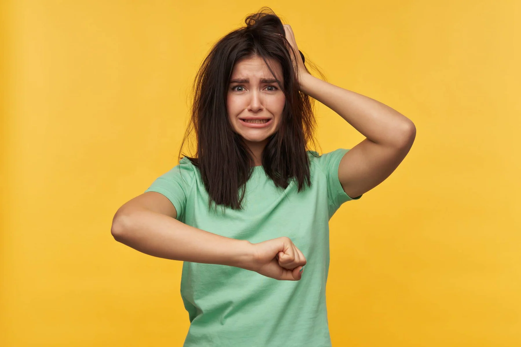 blog 06e6feddcb30 sad disappointed young woman with dark messy hair mint tshirt keeps hands head late job is