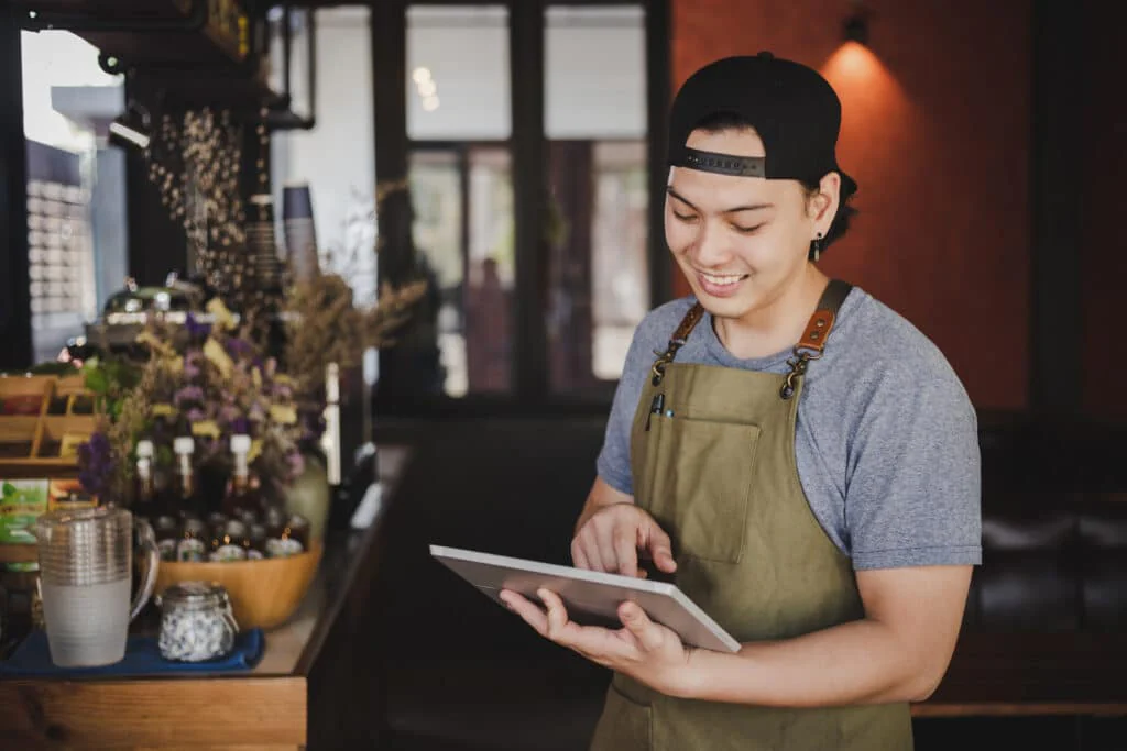 blog 6691d00b2964 asian man barista holding tablet checking order from customer coffee cafe