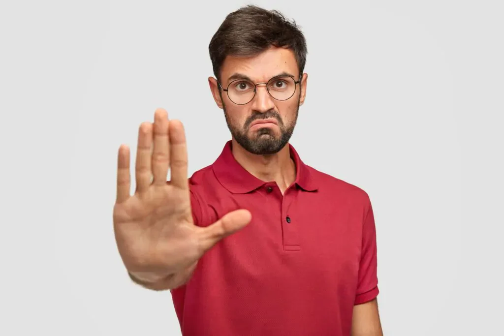 blog 76c9e9c7bcab it s forbidden angry displeased young male frowns face shows stop gesture keeps palm front