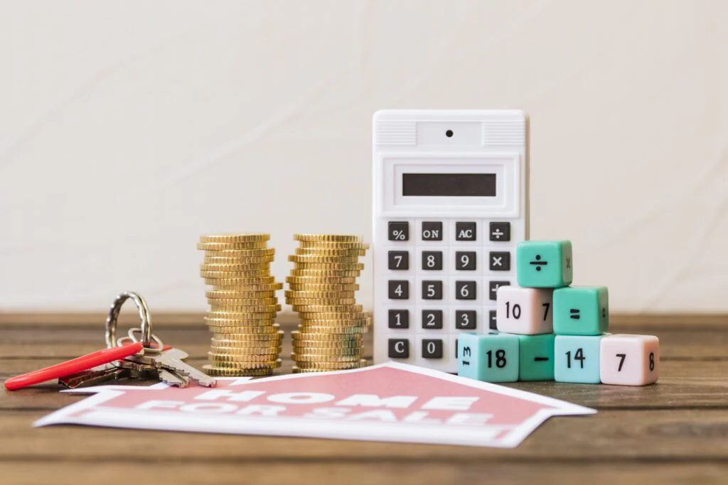 blog ed4473fc0c85 close up home sale icon with key stacked coins calculator math blocks min